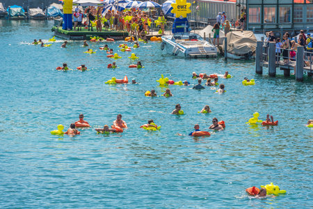 SWITZERLAND, ZURICH - AUGUST 22: 51st Zurich Limmat Swim on August 22, 2015. People have fun participating the swimming summer festival.のeditorial素材