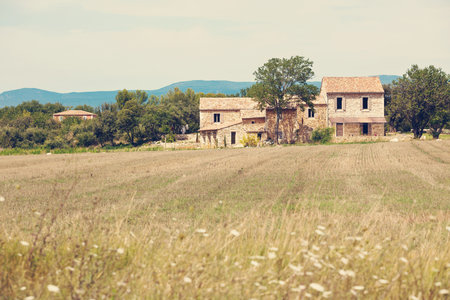 Stone house in a harvested field, Provence, France. Filtered imageのeditorial素材