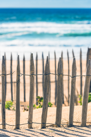Wooden fence on an Atlantic beach in France, The Gironde Department. Shot with a selective focusの写真素材