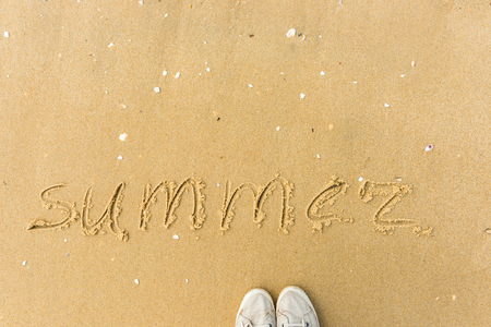 Summer written on the beach. sand backgroundの写真素材