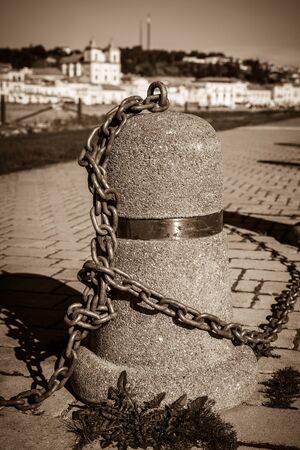Stub posts linked in a chain on a quay in a small Portugal townの写真素材