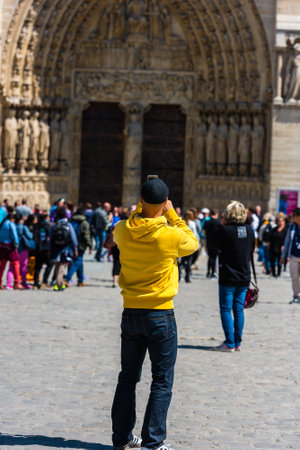 FRANCE, PARIS - JUNE 01: Man taking pictures of the Notre Dame Cathedral in Paris on June 01, 2015のeditorial素材
