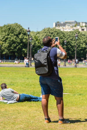 FRANCE, PARIS - JUNE 06: Man taking pictures on the street on June 06, 2015のeditorial素材