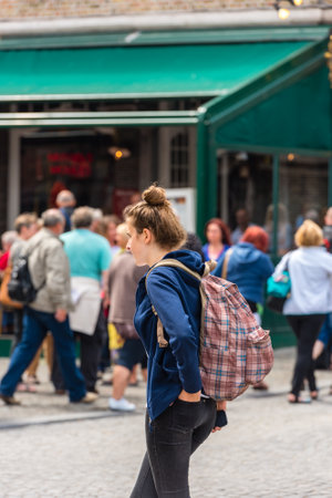 BELGIUM, BRUGES - MAY 26: Beautiful young girl on the street of Bruges on May 26, 2015のeditorial素材