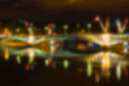 Defocused Cityscape of Lyon, France with reflections in the water at nightの写真素材