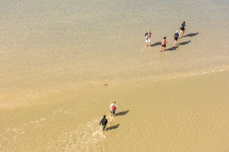 FRANCE, MONT SAINT MICHEL - SEPTEMBER 26: View from walls of Mont Saint Michel on the bay during the low tide with groups of tourists walking. France on September 26, 2015のeditorial素材