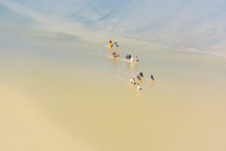 FRANCE, MONT SAINT MICHEL - SEPTEMBER 26: View from walls of Mont Saint Michel on the bay during the low tide with groups of tourists walking. France on September 26, 2015のeditorial素材