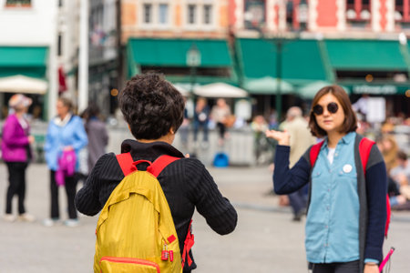BELGIUM, BRUGES - MAY 22: Woman is taking pictures on the street of Bruges on May 22, 2015のeditorial素材