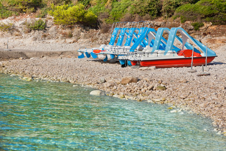 Multicolored catamarans on the pebbles beach in Croatiaのeditorial素材