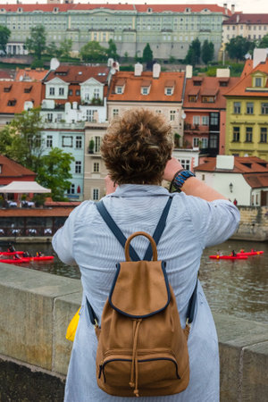 THE CZECH REPUBLIC, PRAGUE - MAY 19: Woman is taking pictures on the Charles bridge in Prague, Czech on May 19, 2015のeditorial素材