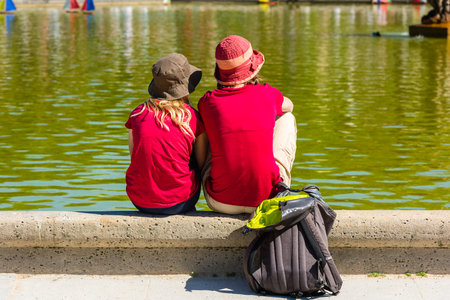 FRANCE, PARIS - JUNE 06: Best friends teenagers sitting at the fountain in summer park on June 06, 2015のeditorial素材
