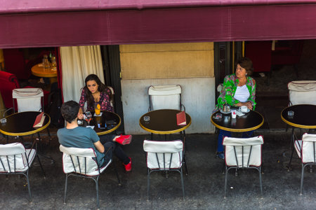 FRANCE, PARIS - JUNE 04: Parisian enjoy food and drinks in cafe sidewalk in Paris on June 04, 2015. Top viewのeditorial素材