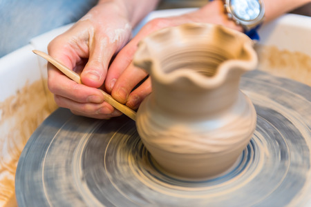 Pottering - creating a clay cup in process. Shot with a small GRIPの写真素材