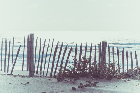 Wooden fence on an Atlantic beach in France, The Gironde Department. Shot with a selective focusの写真素材