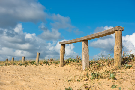 Wooden fence on an Atlantic beach in France, The Gironde Department. Shot with a selective focus
