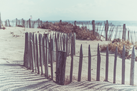 Wooden fence on an Atlantic beach in France, The Gironde Department. Shot with a selective focusの写真素材