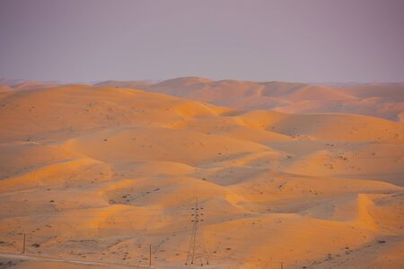 Desert dunes in Liwa, Abu Dhabi, United Arab Emirates during sunsetの写真素材