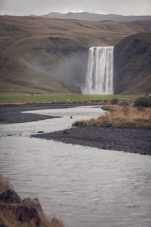 Skogafoss Waterfall, southern part of Iceland, at overcast weatherの写真素材