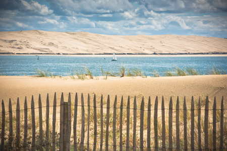 Wooden fence on an Atlantic beach in France, The Gironde Department. Shot with a selective focusの写真素材