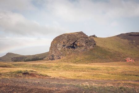 South Icelandic landscape with a house and rainbowの写真素材