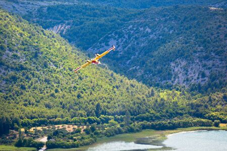 Firefighting plane training near the island and monastery Vysovas, Krka park in Croatia 