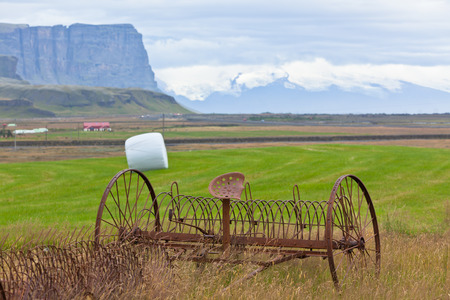 Rusty tractor plows on a field of Icelandの写真素材