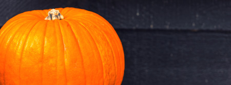Orange pumpkin on a wooden bench. Shot with selective focusの写真素材
