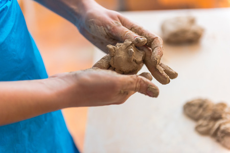 womens hands of a potter creatingの写真素材