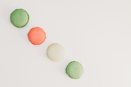 Assorted sweet pastel color macaroons on white background top view. Dessert macaron flat lay.の写真素材