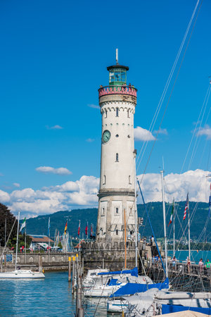 GERMANY, LINDAU - AUGUST 21: view of the lighthouse and a lion statue at the entrance to the port of Lindau at lake Constance, Bodensee on August 21, 2015のeditorial素材