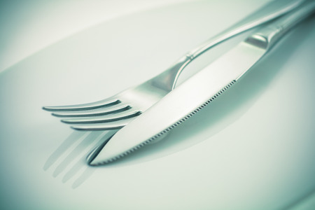 Tableware, cutlery, fork and knife on a white background tonedの写真素材