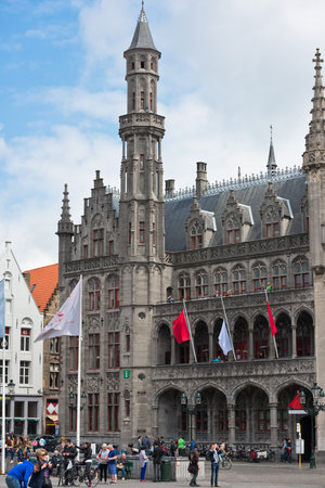 BELGIUM, BRUGES - MAY 26, 2015: Tourists near the building of Historium museum of old Bruges, Belgium on the market square grote marktのeditorial素材