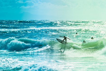 Extreme surfers riding some waves on the sea in Franceの写真素材