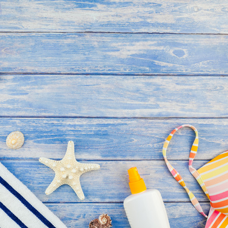 Square Creative flat lay concept of summer travel vacations. Top view of beach towel sunscreen...