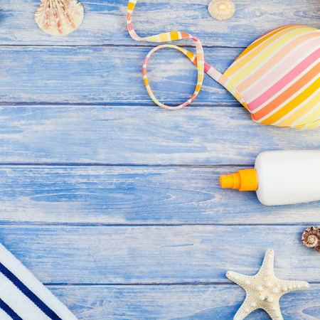 Square Creative flat lay concept of summer travel vacations. Top view of beach towel sunscreen...