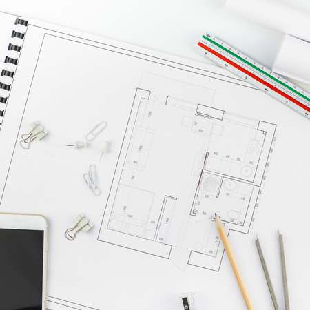 Creative flat lay overhead top view blueprints architectural flat project plan and office supplies on decorator square table workspace with swatches tools and equipment background copy space conceptの写真素材