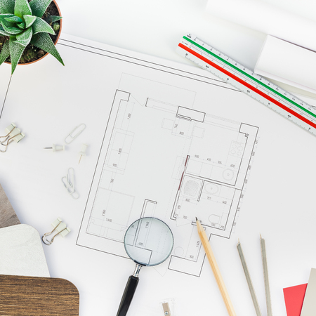 Creative flat lay overhead top view blueprints architectural flat project plan and office supplies...