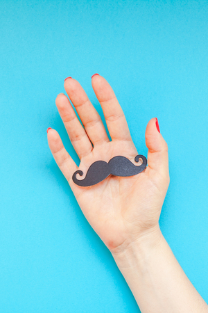Creative flatlay top view retro black paper photo booth props moustaches woman hands turquoise background copy space. Men health awareness month fathers day masculinity concept blog social mediaの写真素材