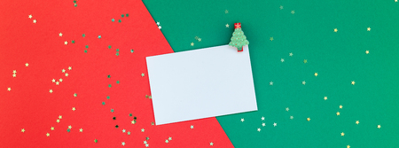 Creative New Year or Christmas greetings letter mockup flat lay top view Xmas holiday celebration envelope on red green paper background. Template mock up greeting card long wide banner 2019 2020の写真素材