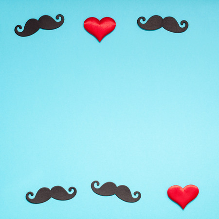 Creative square flatlay overhead top view retro stylish black paper moustaches turquoise background copy space.の写真素材