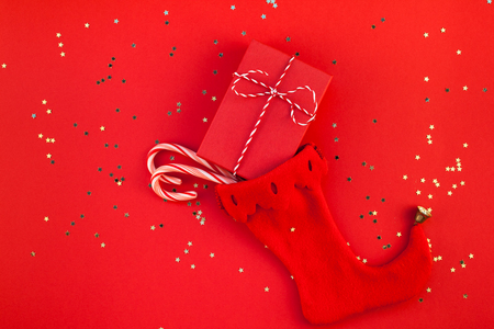 Creative New Year Christmas presents wrapped ribbon flat lay top view Xmas 2019 holiday celebration handmade gift boxes noel stocking red paper background copyspace.の写真素材