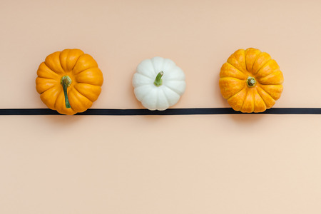 Creative Top view flat lay autumn composition. Frame concept pumpkins color paper background copy space.の写真素材