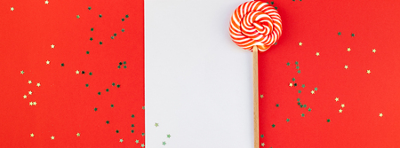 Creative New Year or Christmas greetings letter mockup flat lay top view Xmas holiday celebration envelope on red paper background golden glitter. Template mock up long wide banner 2019 2020の写真素材