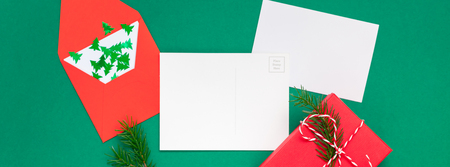 Creative New Year or Christmas greetings letter mockup flat lay top view Xmas holiday celebration envelope on green paper background. Template mock up greeting card text design 2019 Long wide bannerの写真素材