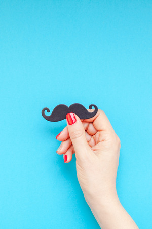 Creative flatlay top view retro black paper photo booth props moustaches woman hands turquoise background copy space. Men health awareness month fathers day masculinity concept blog social mediaの写真素材