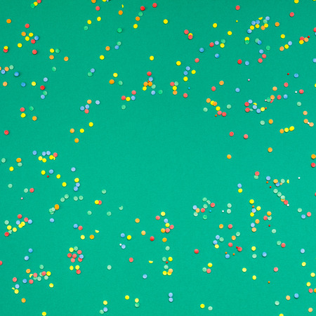 New Year or Christmas pattern 2019 flat lay top view Xmas holiday celebration green paper colorful confetti background. Template for greeting card your text designの写真素材