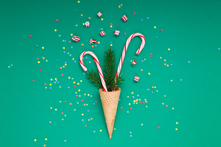 New Year Christmas Xmas holiday party celebration waffle cone candy canes fir tree branch copy space green color paper background. Template greeting card 2019の写真素材