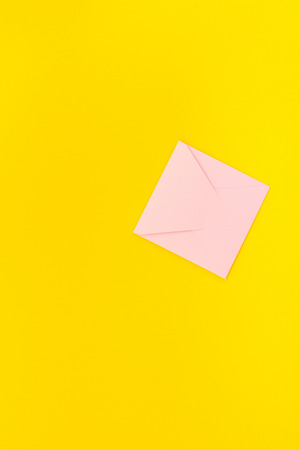 Small love millennial pink letter with copy space on bold yellow background in creative minimal style. Concept template for Valentine holiday feminine blog social mediaの写真素材
