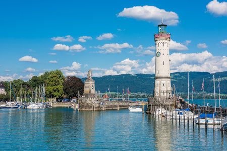 GERMANY, LINDAU - AUGUST 21: view of the lighthouse and a lion statue at the entrance to the port of Lindau at lake Constance, Bodensee on August 21, 2015のeditorial素材