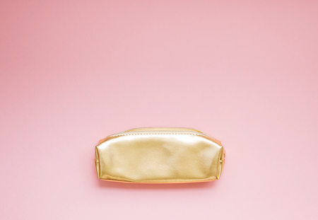 Top view flat lay of empty golden female purse copy space millennial pink color paper background minimal style. Template for feminine blog social mediaの写真素材